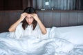 Woman having migraine headaches during lying in bed at home. insomnia, sleepless, tired, suffering and stressed concepts Royalty Free Stock Photo