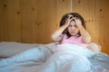 Woman having migraine headaches during lying in bed at home. insomnia, sleepless, tired, suffering and stressed concepts Royalty Free Stock Photo