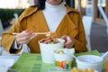 Woman having noodles meal in the restaurant from the paper box Royalty Free Stock Photo