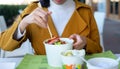 Woman having noodles meal in the restaurant from the paper box Royalty Free Stock Photo