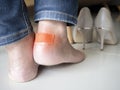 Female using bactericidal medical adhesive plaster. Foot skin care