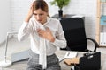 Woman having panic attack at workplace
