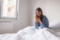 Woman having phone conversation in bed Royalty Free Stock Photo