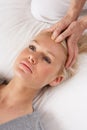 Woman having Shiatsu massage to head