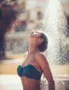 Woman having shower under tropical waterfall, bali. Royalty Free Stock Photo