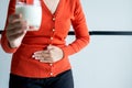 Woman having a stomach ache and hands holding a glass of milk,Allergy dairy intolerant,Lactose intolerance concept Royalty Free Stock Photo