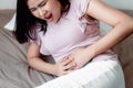 Woman is Having Stomach Ache or Menstrual Period, Close-Up Portrait of Young Woman is Suffering From Abdominal Pain at Her Home. Royalty Free Stock Photo