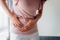 Woman is Having Stomach Ache or Menstrual Period, Close-Up Portrait of Young Woman is Suffering From Abdominal Pain at Her Home. Royalty Free Stock Photo