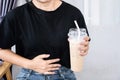 Woman having stomachache after drinking coffee because of too much gastric acid in caffeine