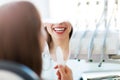 Woman having teeth examined at dentists