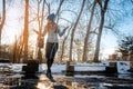 Woman having to step into a puddle of water and thawing snow