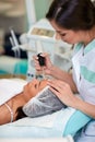 Woman having treatment of beautification cosmetic salon