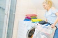 Woman holding laundry basket full of clothes Royalty Free Stock Photo