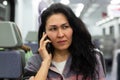 Woman having unpleasant phone talk in train Royalty Free Stock Photo