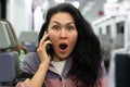Woman having unpleasant phone talk in train Royalty Free Stock Photo