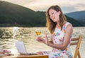 Woman having a video call by the lake Royalty Free Stock Photo