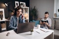 Woman having video call on laptop while man reading book Royalty Free Stock Photo