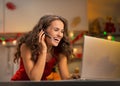 Woman having video chat on laptop in kitchen Royalty Free Stock Photo