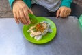 Woman having Vietnamese steamed rice rolls with chili fish sauce