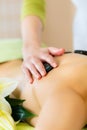 Woman having wellness hot stone massage Royalty Free Stock Photo