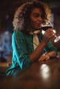 Woman having wine at bar counter Royalty Free Stock Photo