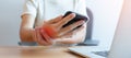 Woman having wrist pain when using mobile phone during working long time on workplace. De Quervain s tenosynovitis, ergonomic, Royalty Free Stock Photo