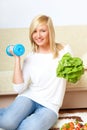 Woman with a head of lettuce and dumb-bell