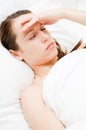 Woman with headache in her bed