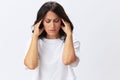 Woman headache and sadness, stress and depression, woman in a white t-shirt on a white background illness, copy space Royalty Free Stock Photo
