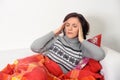 Woman with a headache sitting on the couch Royalty Free Stock Photo