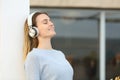Woman with headphones breathing fresh air on a terrace Royalty Free Stock Photo