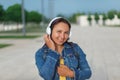 Woman in headphones. young woman in headphones listening music outdoors