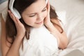 Woman in headphones listening pleasant music