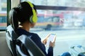 Woman With Headphones Listening To Music Commuting By Bus