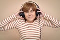 Woman with headphones listening very loud music Royalty Free Stock Photo