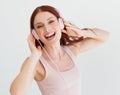 Woman, headphones and studio portrait with smile for music, streaming subscription or podcast by background. Isolated