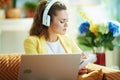 Woman with headphones subscribing to online education website Royalty Free Stock Photo