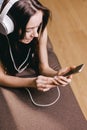 Woman with headphones watching movie on smart phone