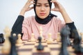 Woman with two hands on head while playing chess Royalty Free Stock Photo