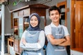 woman in headscarf and young man in apron smiling Royalty Free Stock Photo