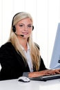 Woman with a headset and computer Hotline at