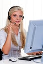 Woman with a headset and computer Hotline at