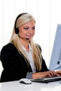 Woman with a headset and computer Hotline