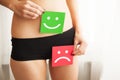 Woman Health Problem. Closeup Of Female With Fit Slim Body In Panties Holding Two Card With Sad Smiley And Happy Face Royalty Free Stock Photo