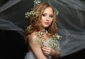 Woman with healthy blonde hair and white flowers on black background