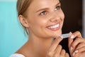 Woman With Healthy White Teeth Using Teeth Whitening Strip Royalty Free Stock Photo