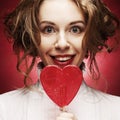 Woman with heart caramel over red background Royalty Free Stock Photo