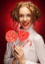 Woman with heart caramel over red background Royalty Free Stock Photo