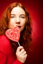 Woman with heart caramel over red background Royalty Free Stock Photo