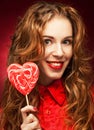 Woman with heart caramel over red background Royalty Free Stock Photo